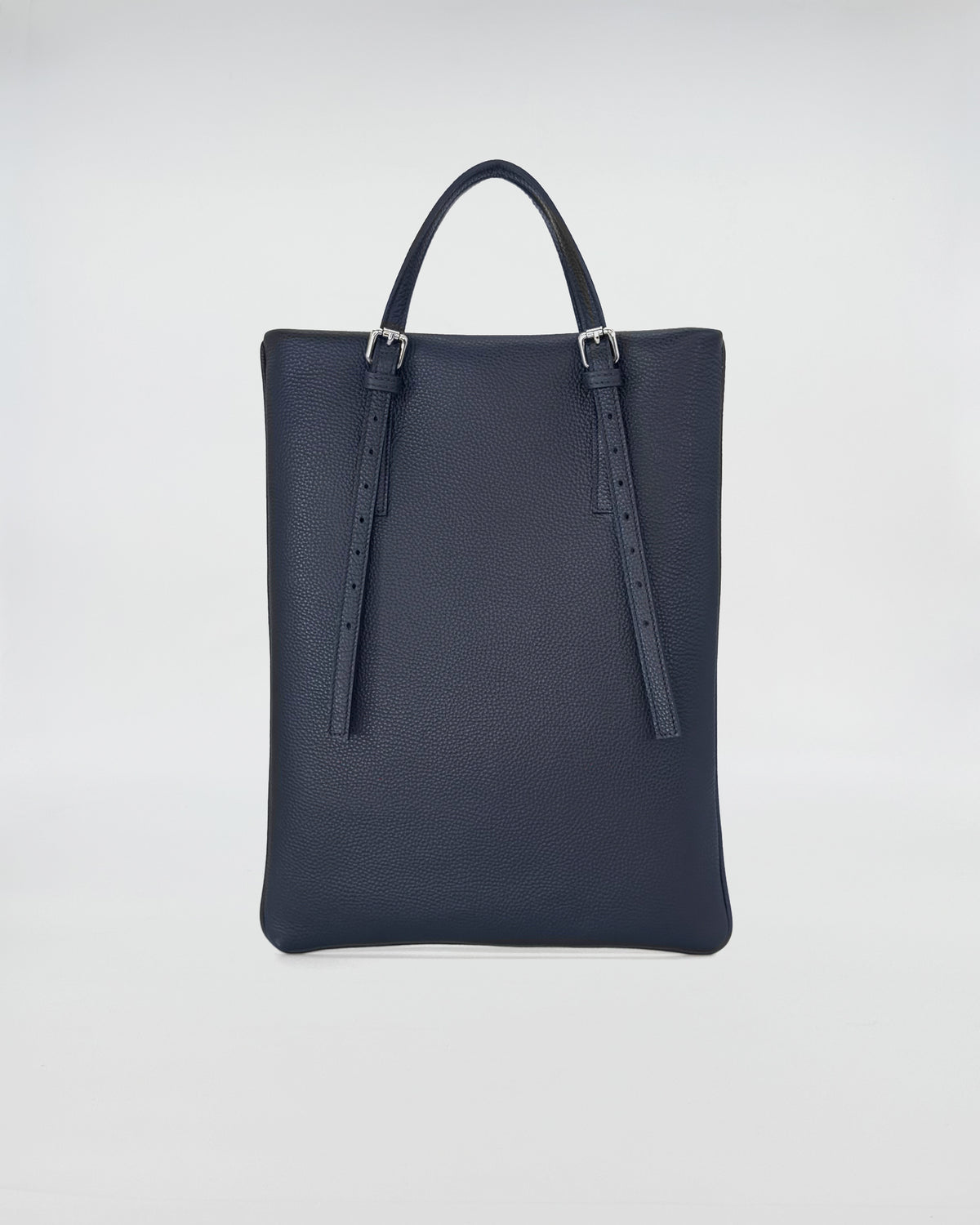 AMELIE PORTACOMPUTER versatile computer bag in dark navy leather with adjustable handles.