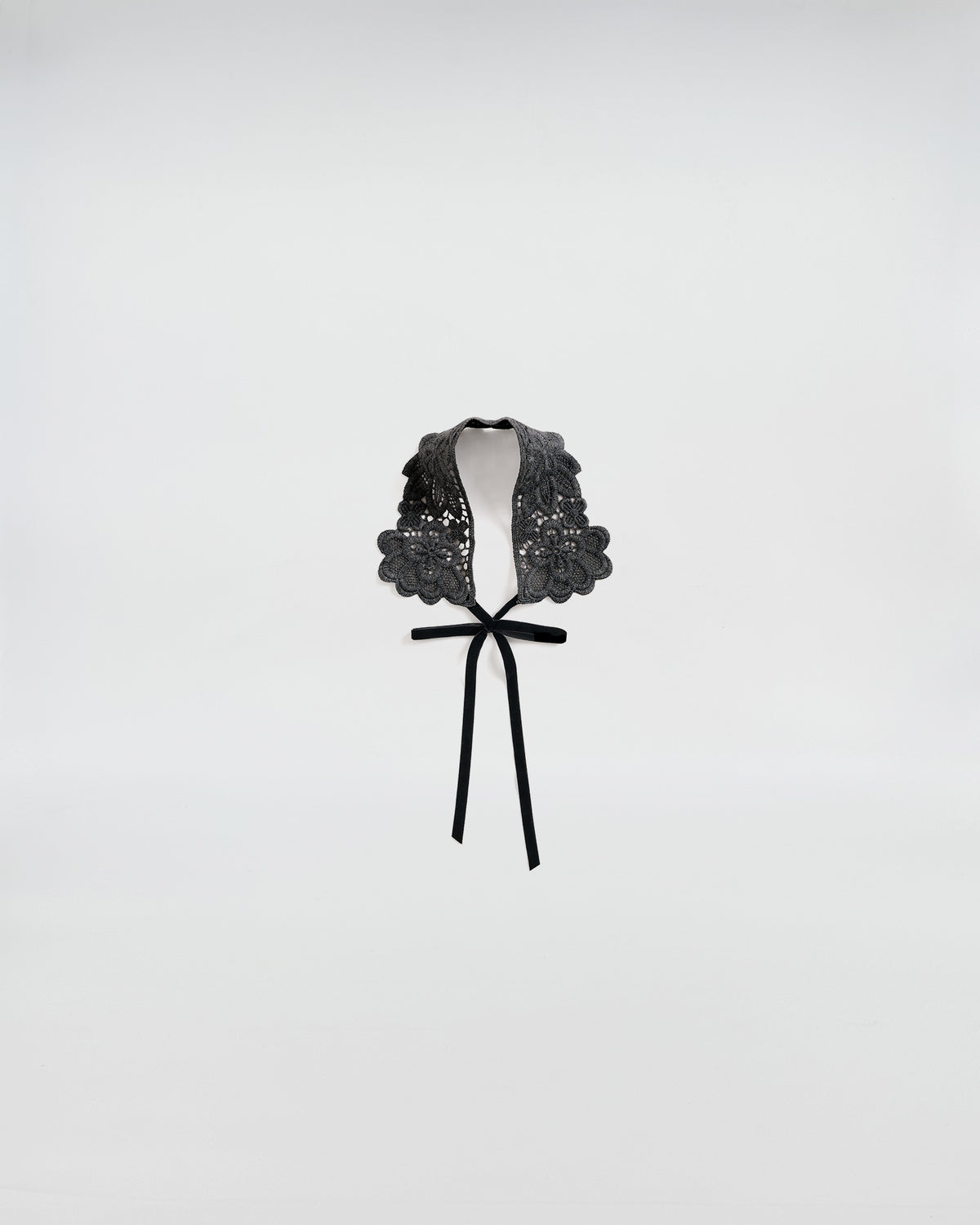 Black macramé lace collar with bow, adding a touch of elegance and femininity to any outfit.