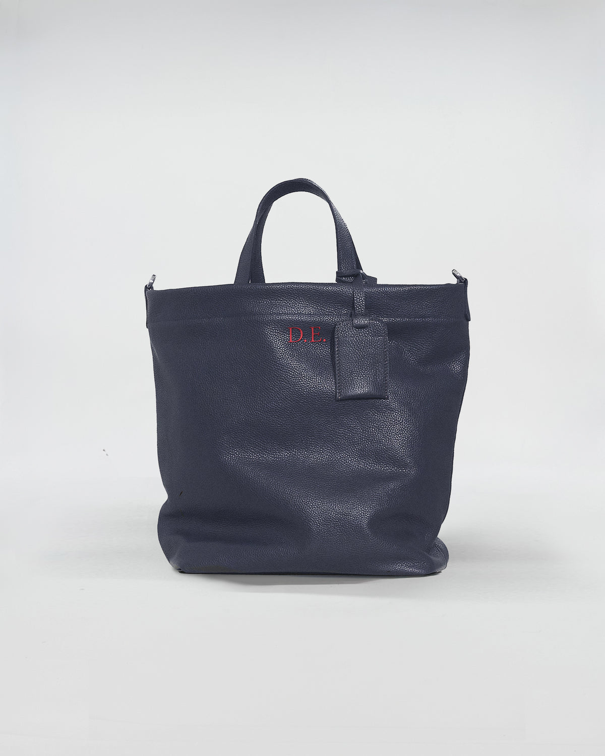 Borsa FORD PERSONALIZZATA in pelle blu con manici e etichetta, elegante e funzionale per uso quotidiano.