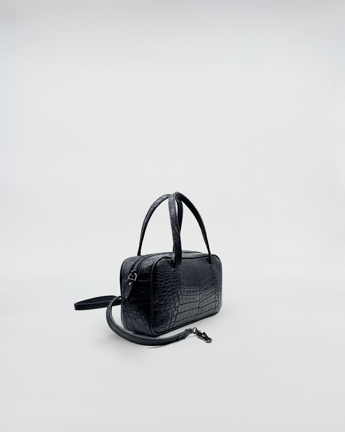 GINEVRA COCCO RECYCLE elegant black recycled crocodile leather handbag with a sophisticated design and soft suede interior.