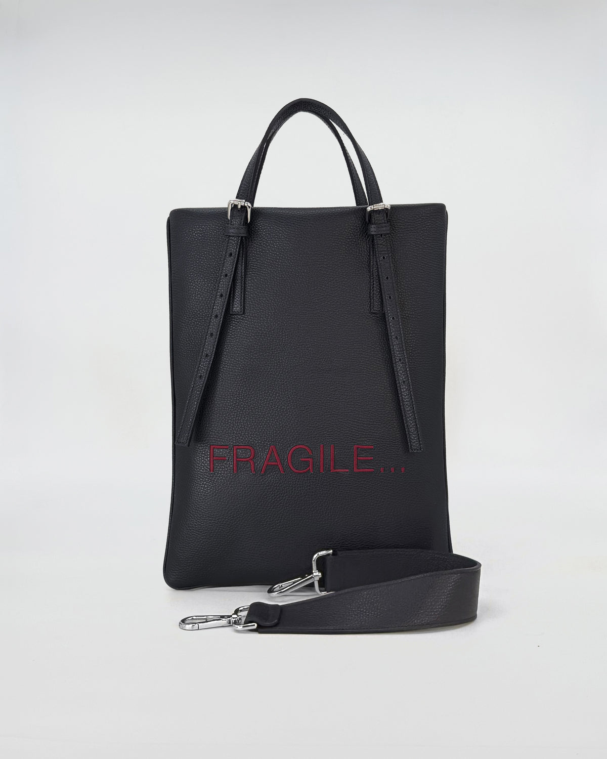 AMELIE PORTACOMPUTER in black leather with adjustable straps and fragile print design.