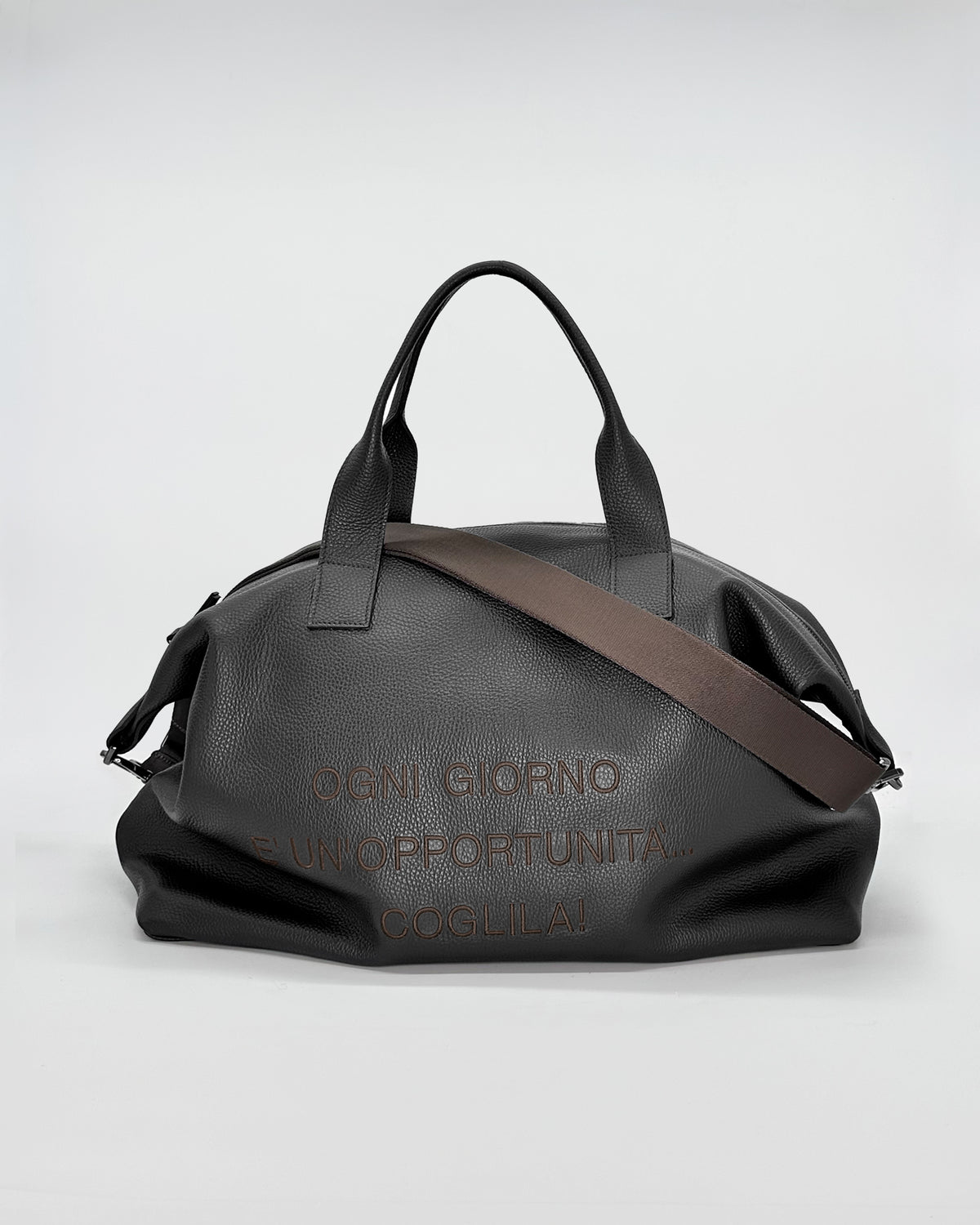 Black travel bag with adjustable strap, featuring motivational text and a sleek design for versatile use.