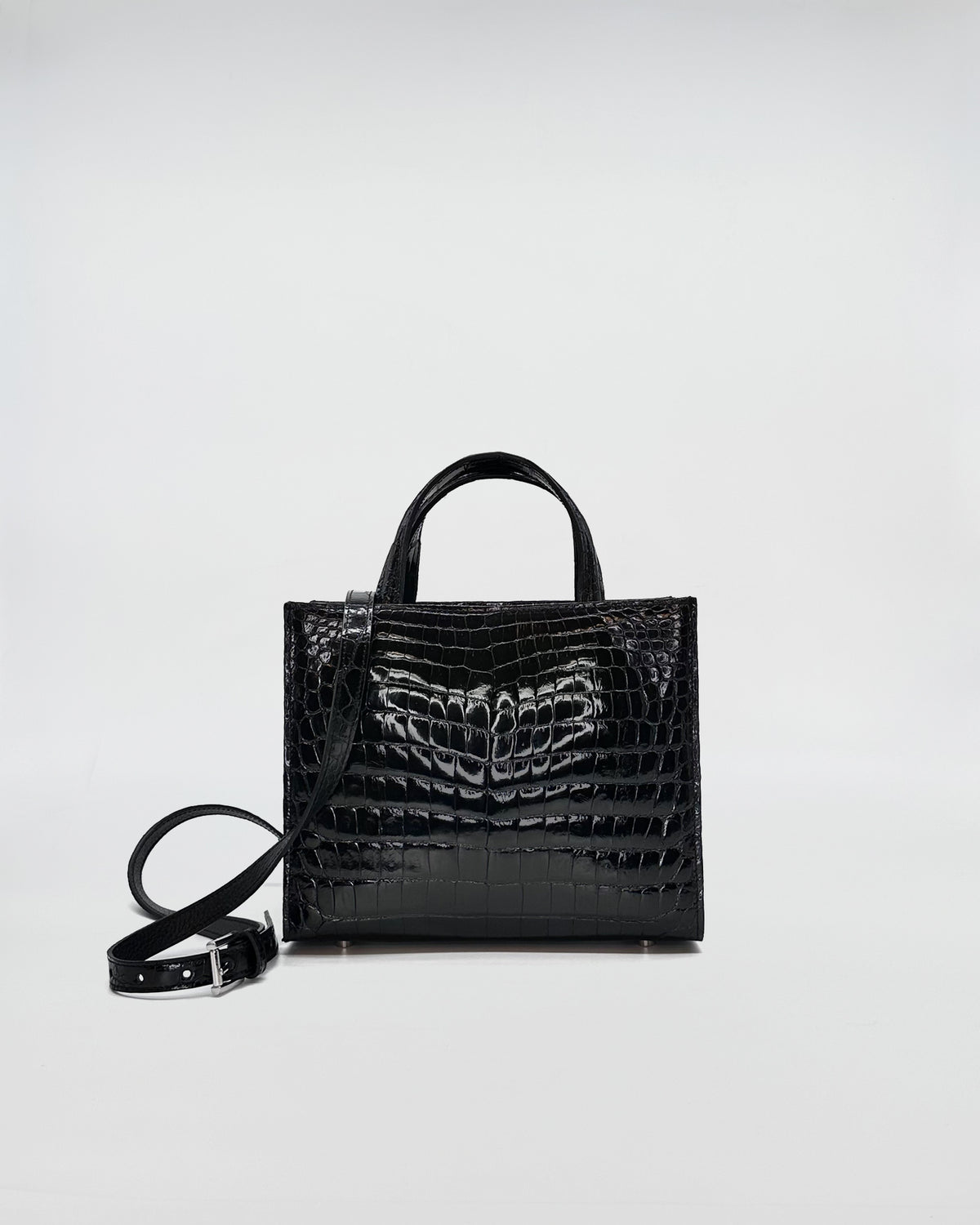 Black coccodrillo recycle handbag with dual handles and crossbody strap, showcasing sleek design and elegant finish.