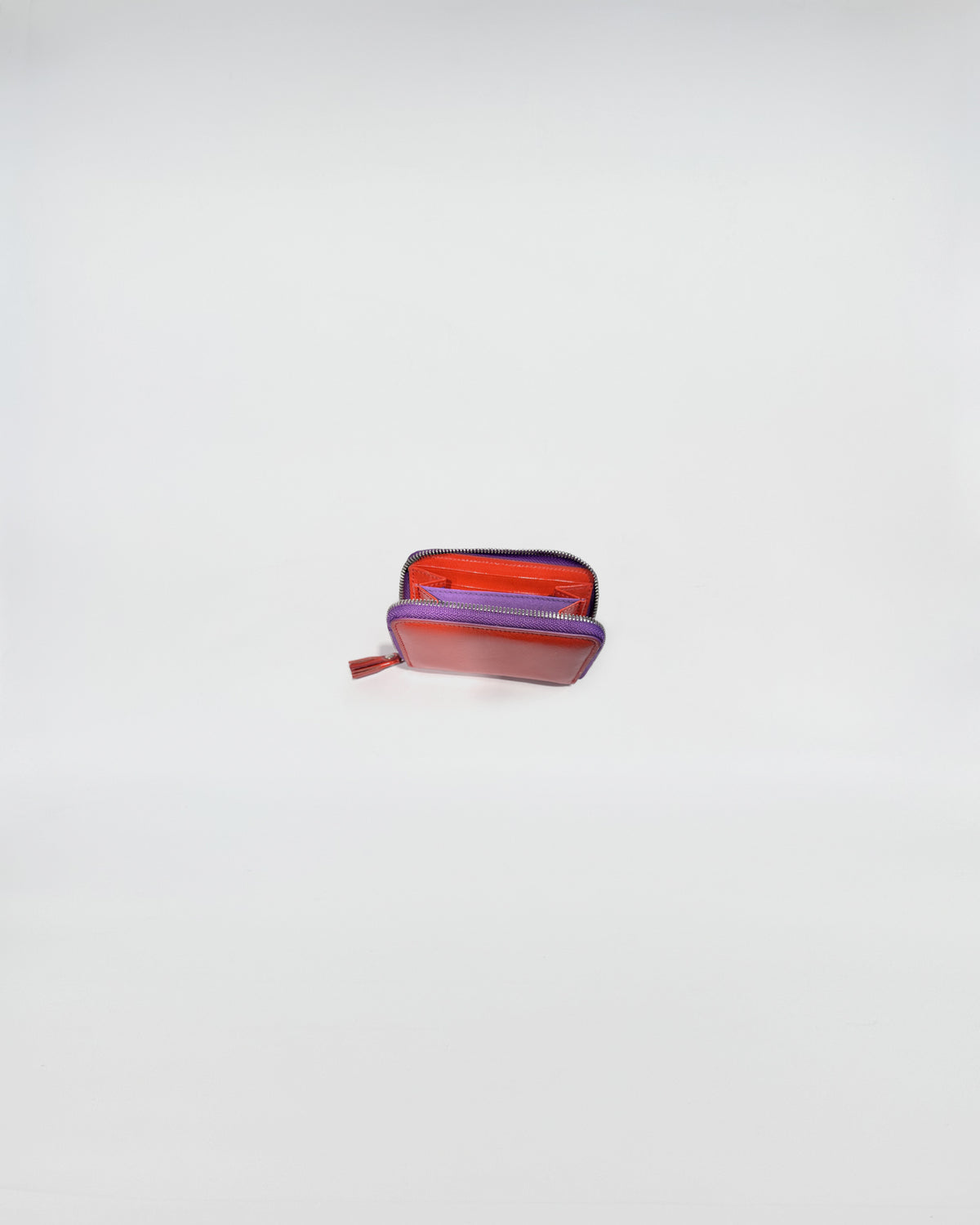 Portafoglio Zip Mini in vitello con chiusura a zip viola, interni ben organizzati per carte e contanti.