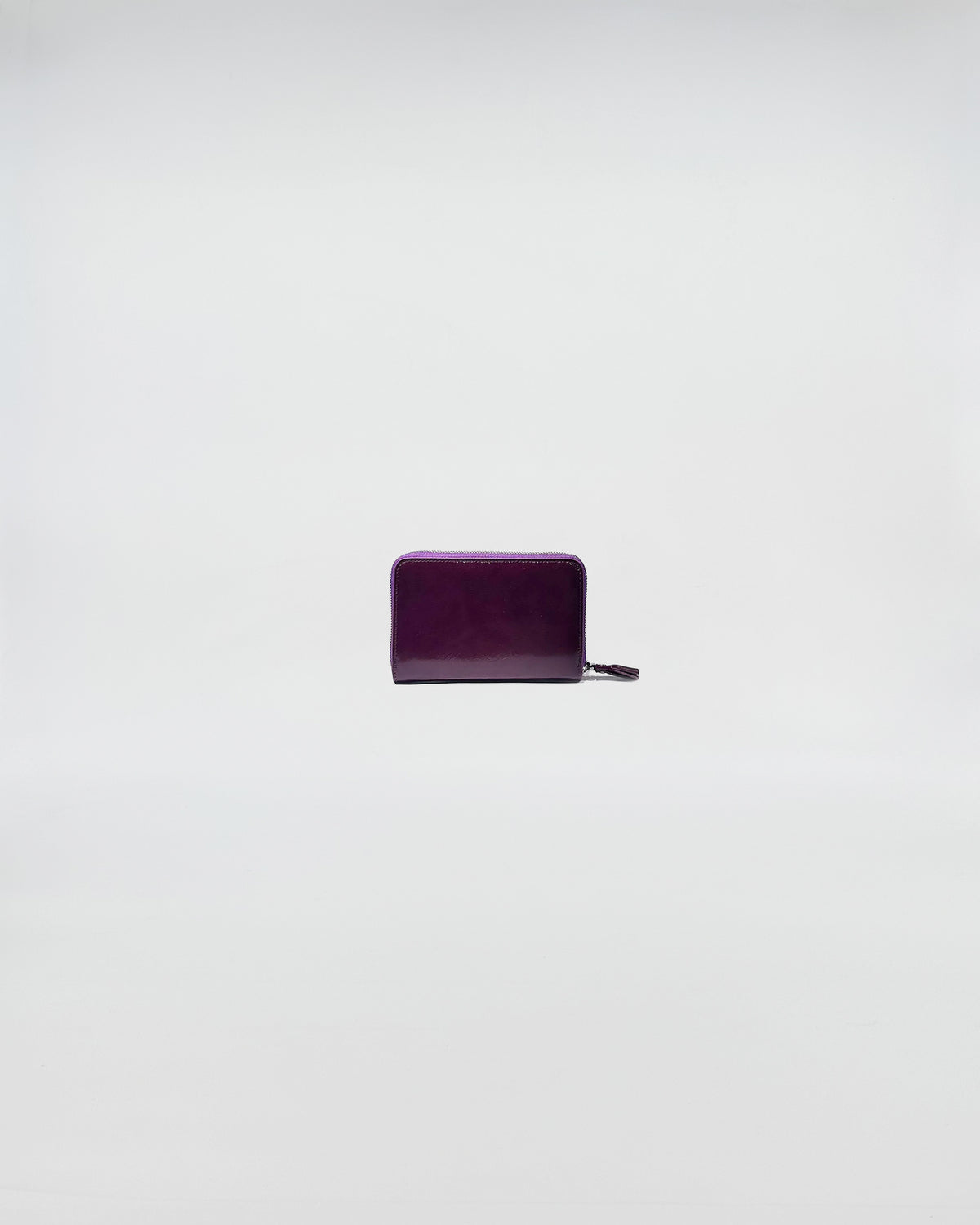 PORTAFOGLIO ZIP MINI in purple leather with zip closure, featuring a sleek and sophisticated design.