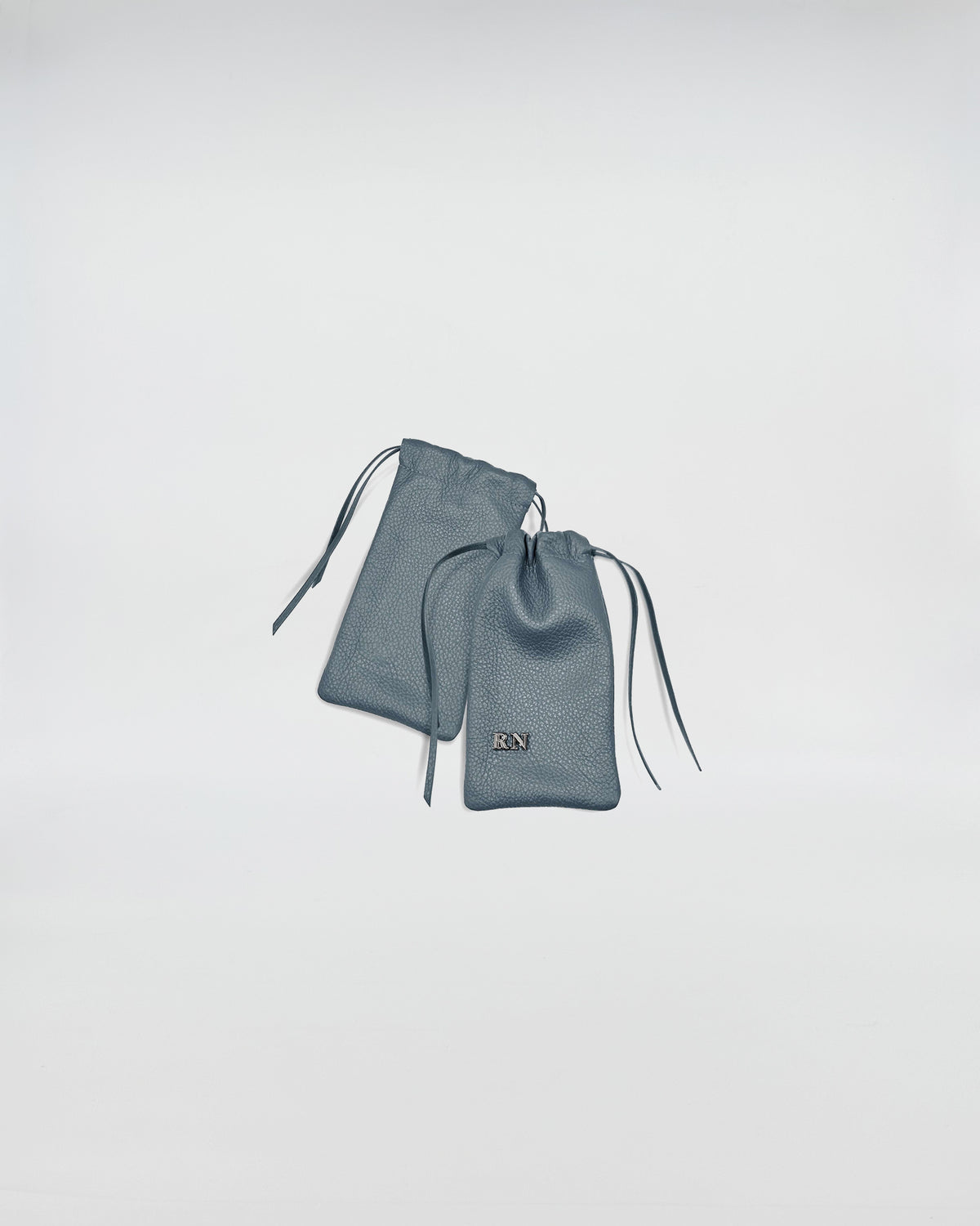 PORTA OCCHIALI LEO blue leather cases with drawstring closure and branded logo.